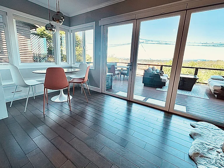 Breakfast nook off kitchen tri fold doors out to large deck.