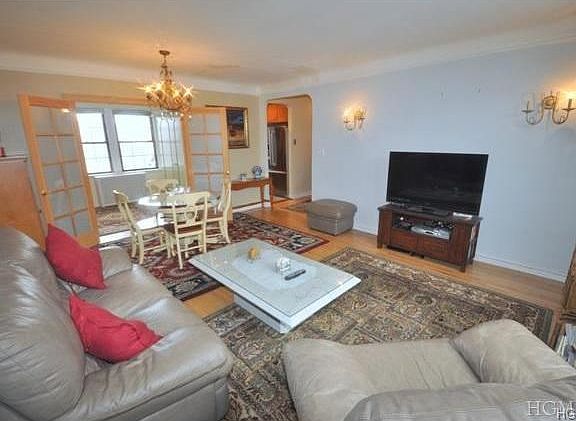 Large bright living room overlooks the courtyard and has refinished hardwood floors.  There are French doors that open to a dining room that is currently being used as a second bedroom.  The room is 18'-0" x 14'-2"