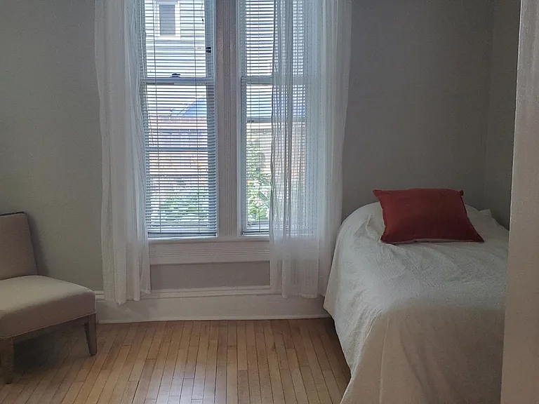 The bedroom off the dining room. This could be a bright office space.