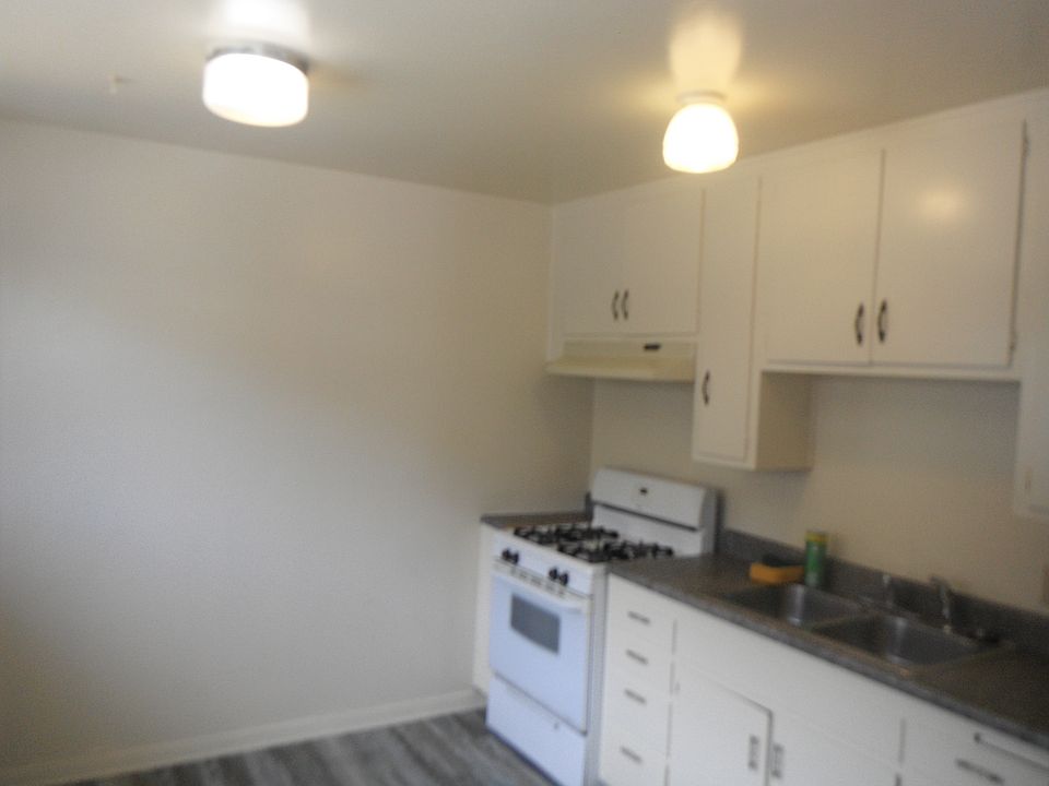 Kitchen area with new paint, flooring, and countertop.