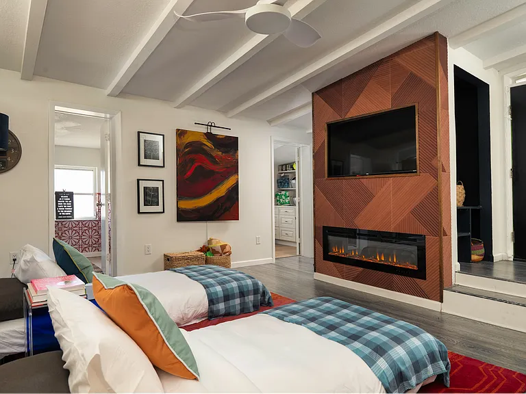Wide armless chairs in "Sunken Living Room" convert into single beds for guests.