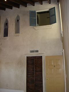 Window in Master bedroom overlooks the Living room