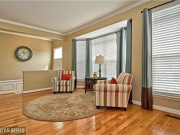 Light-filled living room  gleaming wood floors