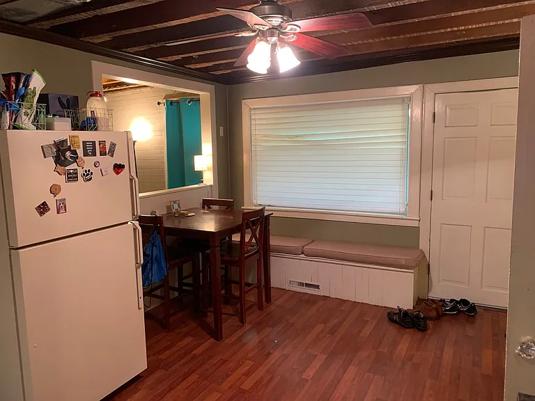 old pic of kitchen shown with prior tenants furniture