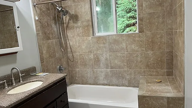 bathroom with tub and shower