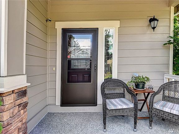Covered front porch with storm door to enjoy any weather.