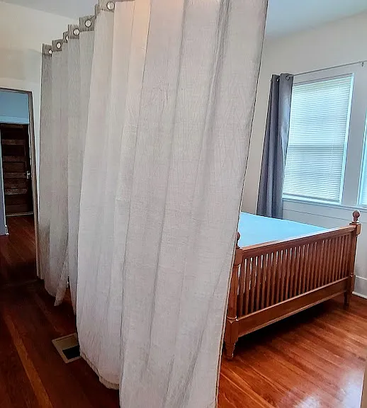 Moveable curtain in Queen Bedroom creates visual privacy.