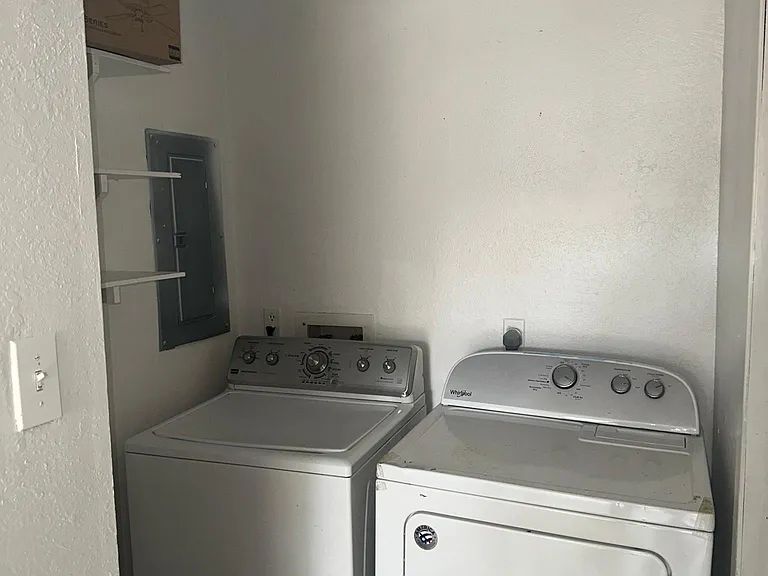 Washer and dryer connections and half bath area past the kitchen