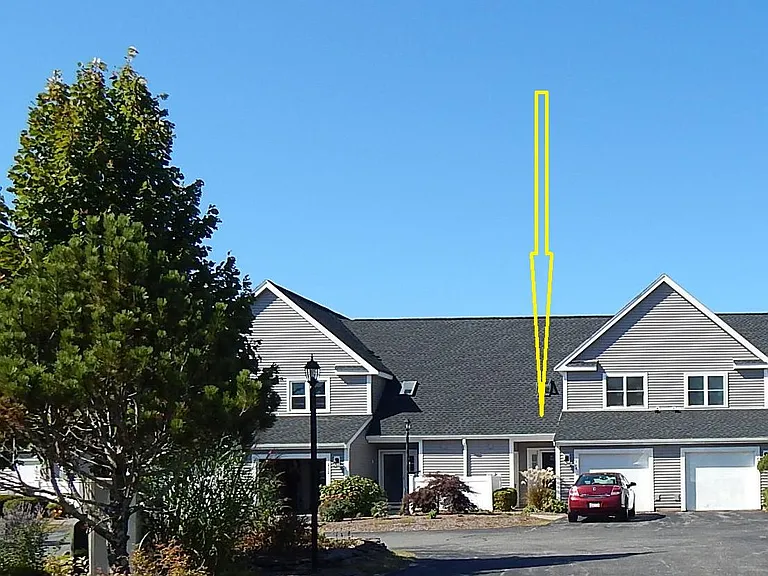 Townhome with attached single garage and single parking space in front of garage