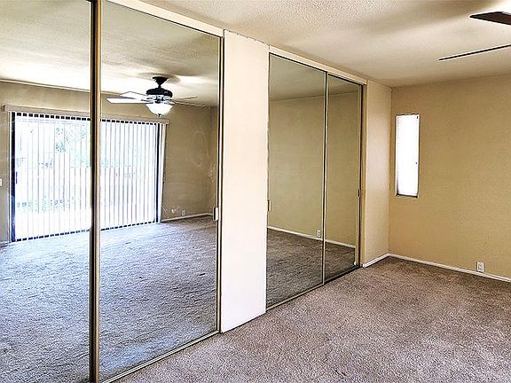 Master suite with dual mirrored closets.