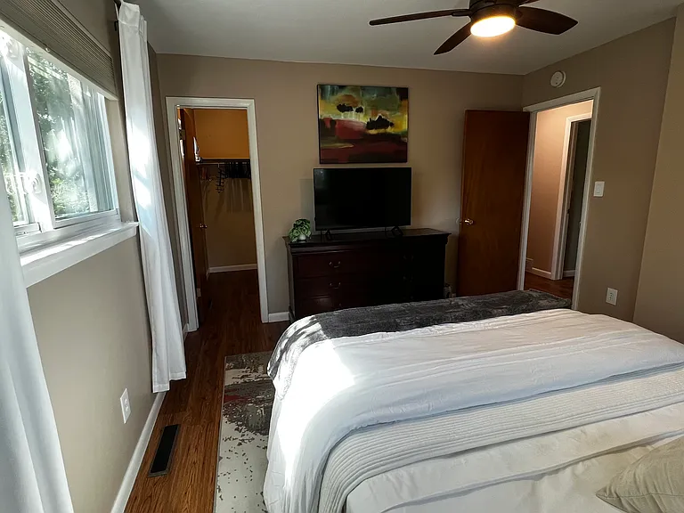 Alternate view of the primary bedroom showing generous closet space and easy access to the hall bathroom.