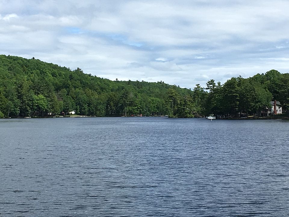 view from bridge connecting two lakes to the house down in t
