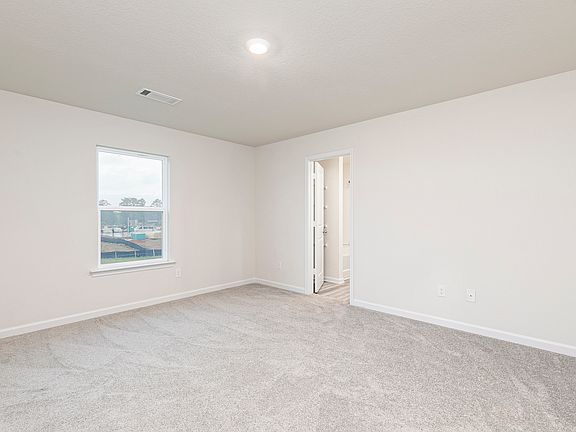 The master bedroom offers plenty of bright light and space for all of your furniture