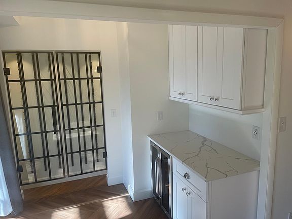 Wine cooler and an enclosed wine wall rack with additional access to the patio area. Great for entertaining.