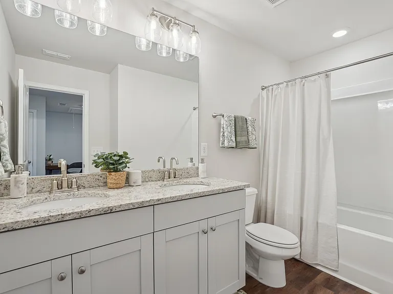 Secondary suite bathroom with a tub and shower combination