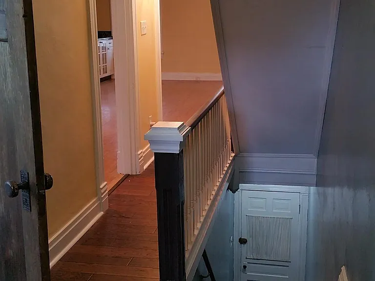 This is a second and thrid floor 2 bedroom apartment. This is the front stair entrance - door at floor and hallway looking from Kitchen doorway into front of home. The back has a second for private entrance into the kitchen