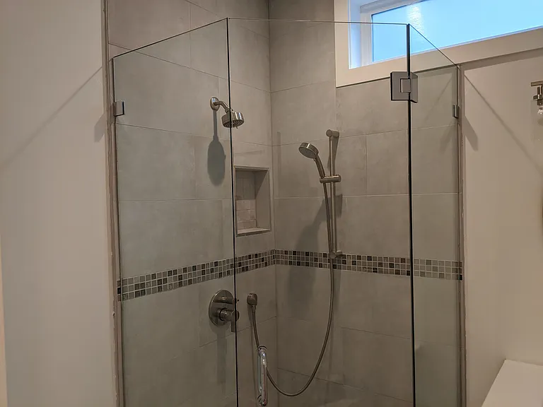 large walk in shower in hallway bathroom