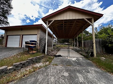 Side of house with 2 car garage and boat storage
