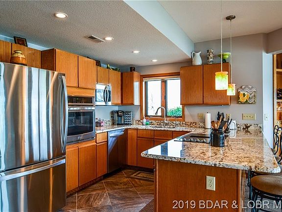 The kitchen holds plenty of cabinet space, and the breakfast bar brings that extra bit of space perfect for entertaining.