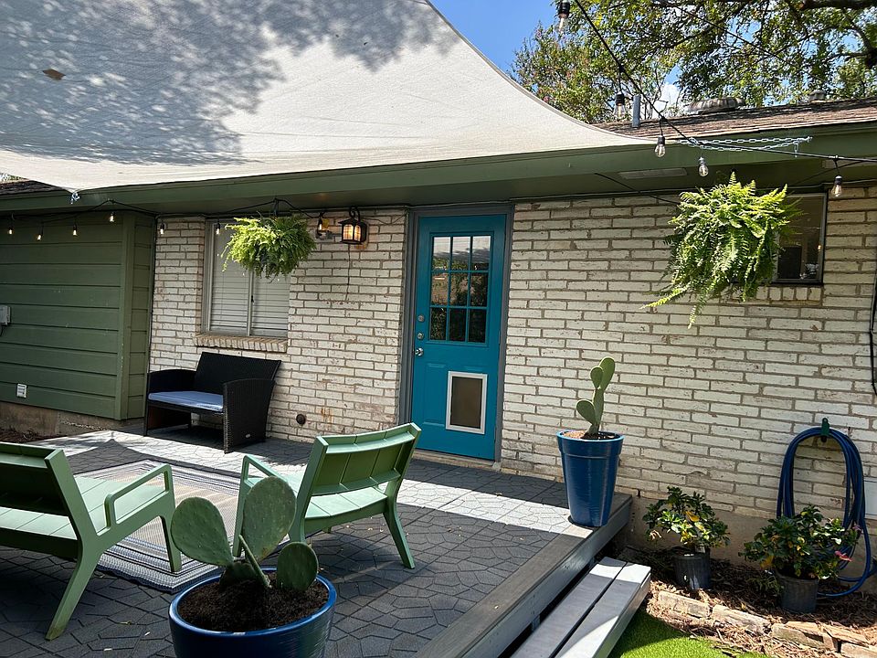 Generous back deck with sun shade and artificial turf for enduring beauty