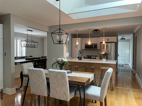 Dining room/kitchen with sunlight and sliding glass doors to the patio.