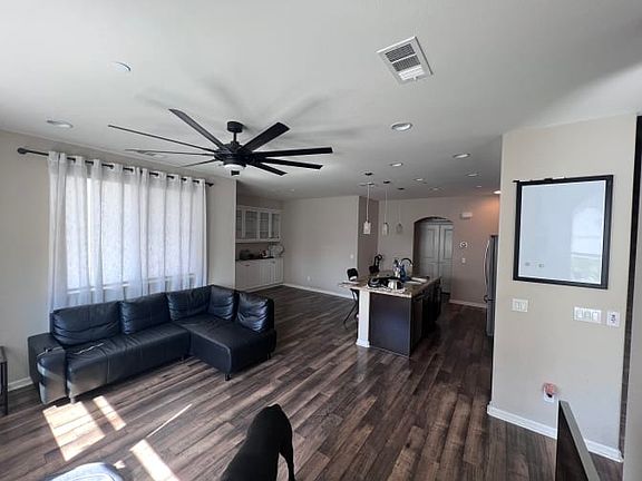 Main living spaces include the kitchen, living room, and outdoor patio.