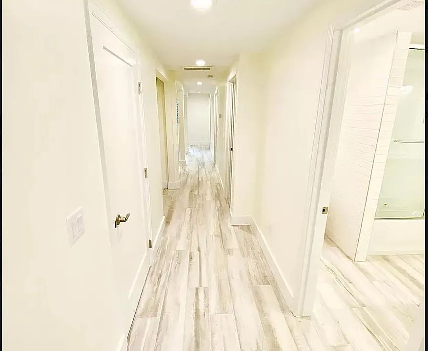 Downstairs hallway to three bedrooms and wet bar. All rooms have large windows