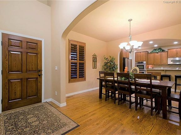 The hardwood entry opens into the formal Dining Room and Kitchen