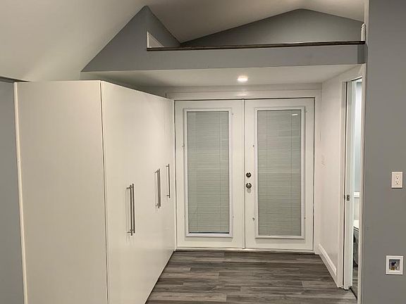 Entryway with storage loft above and plenty of closet space.