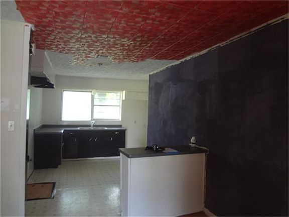 Living area looking into dining and kitchen