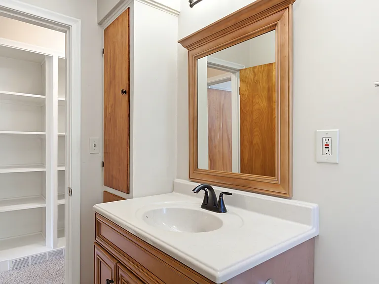 Bathroom vanity. Nice large mirror.