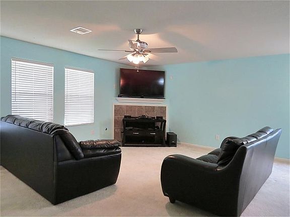 Open and spacious living room with tile-surround fireplace!