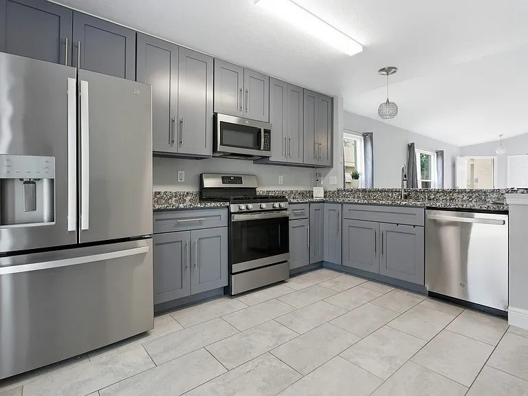 Kitchen with all stainless steel appliances, gas range soft close cabinets & granite counter tops