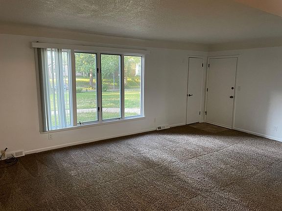 Living room, front casement window, front closet, and front door.