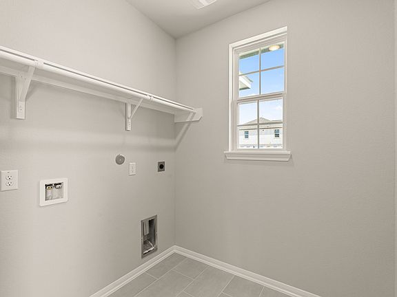 The utility room also located off of the garage and is light and bright