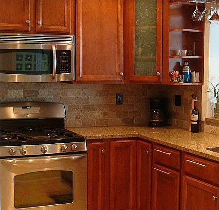The renovated kitchen features granite countertops, tile backsplash, stainless steel cooktop, microwave & dishwasher and tons of cabinet space.