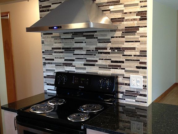 Beautiful tile backsplash and modern stove hood