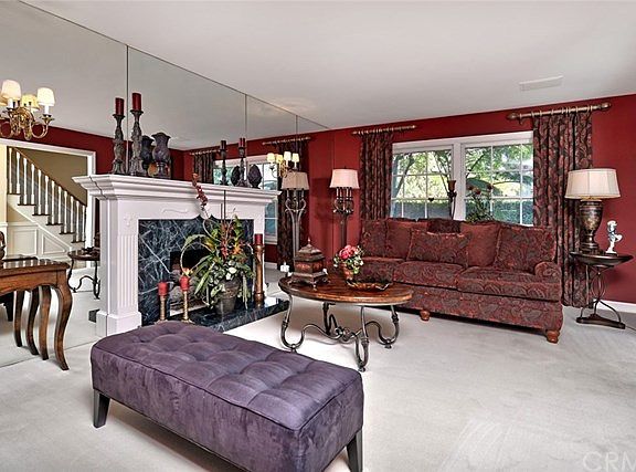 The marble faced surround and hearth of the fireplace is a stunning focal point for the living room!