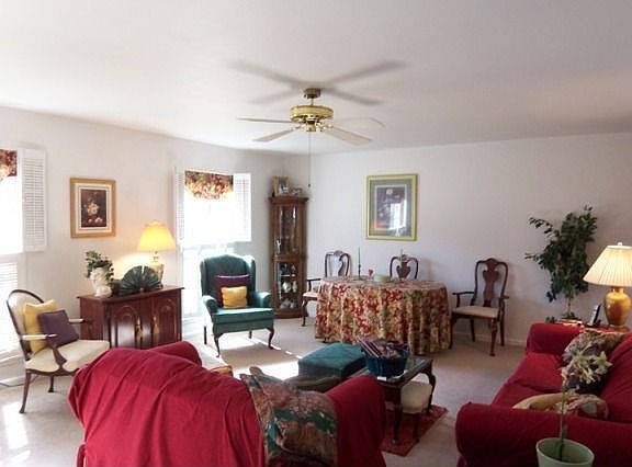 Living room w/ shutter window treatments
