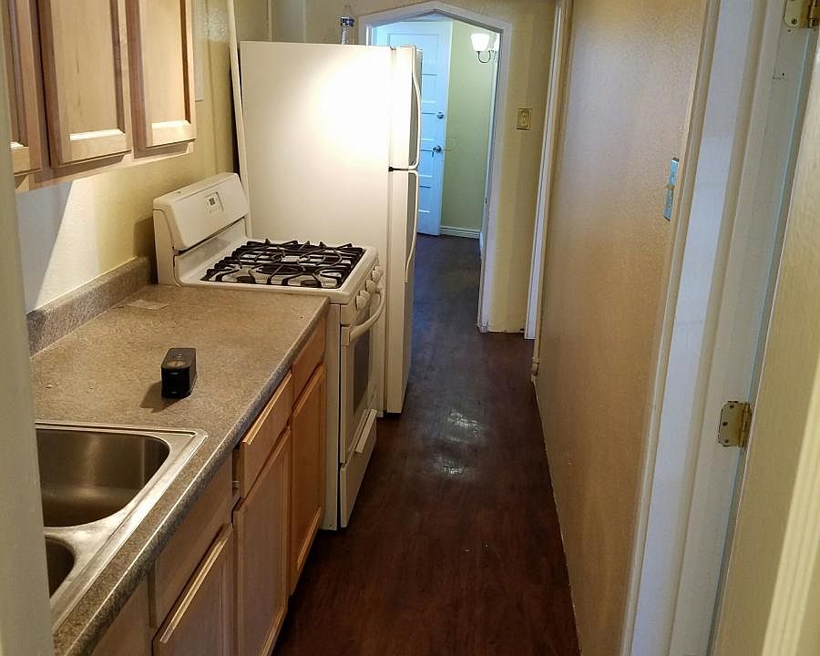 Kitchen and passage to bath