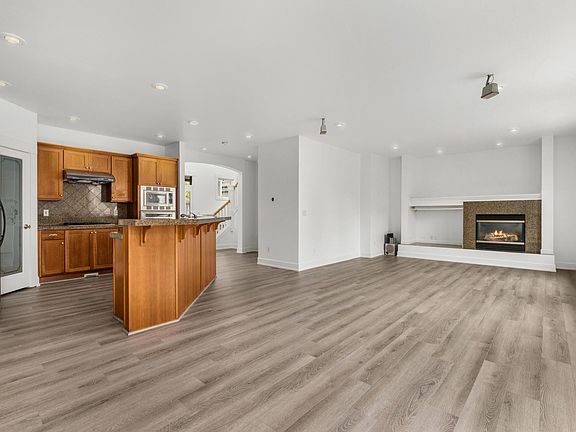 Open concept on the main level with a chef's kitchen, gas cooking and a gas fireplace. There is a powder room on this level!