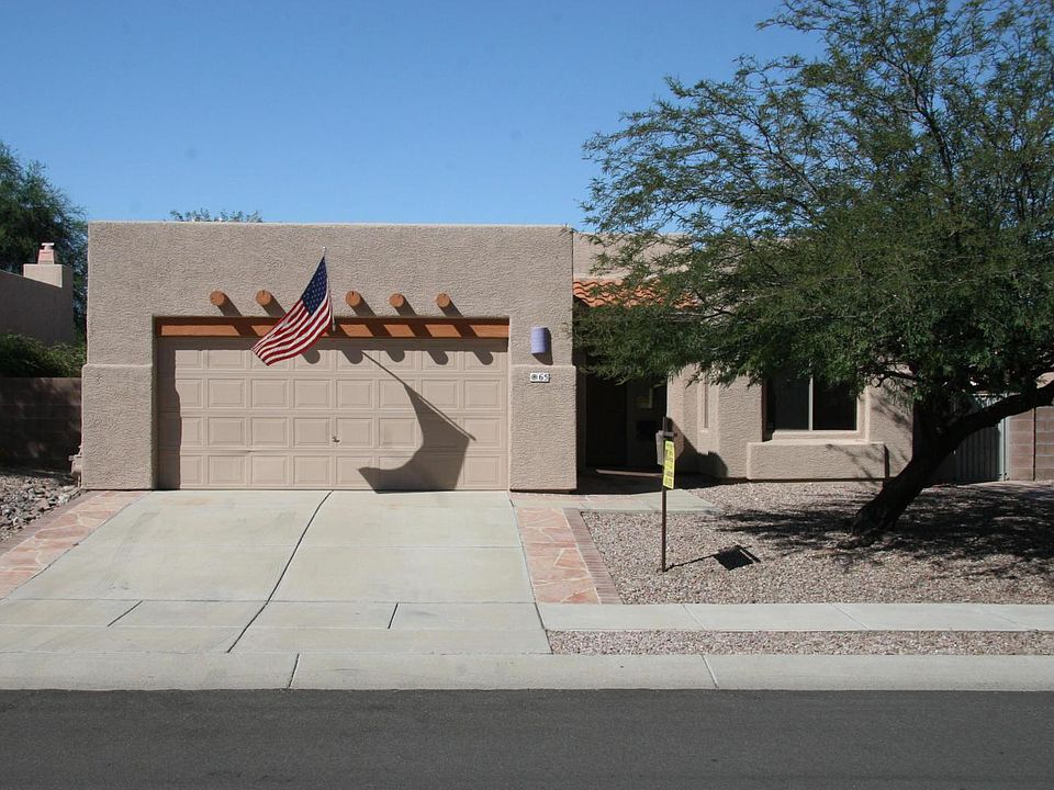 Front of home with beautiful tree