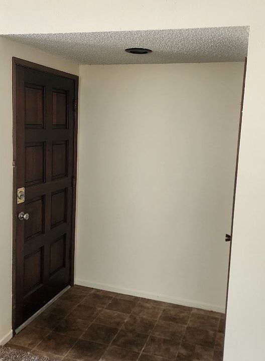 Tiled entry with coat closet.