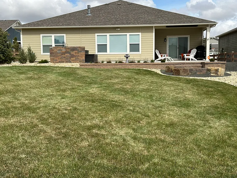 Beautifully landscaped backyard with covered patio