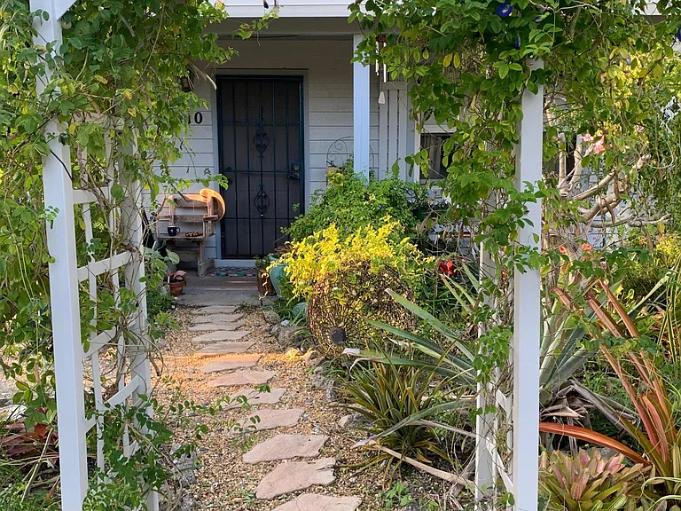 Welcome! Come up the path to my front door. I'll show you around to your entrance in the back. Note: trellises blew away (knocked over and dragged away) in Milton.