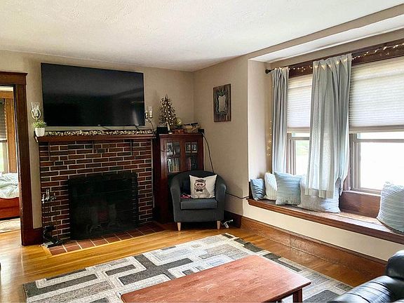 Living room- room to the left of the fireplace is the sun parlor. Perfect for an office space with lots of natural light