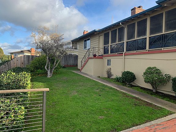 View of backyard from deck with lemon tree.