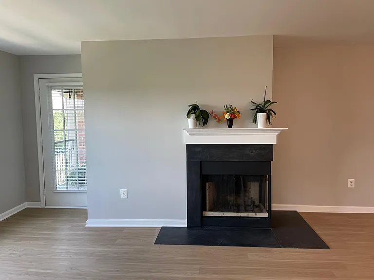 Living area view with decorative fireplace and balcony entrance
