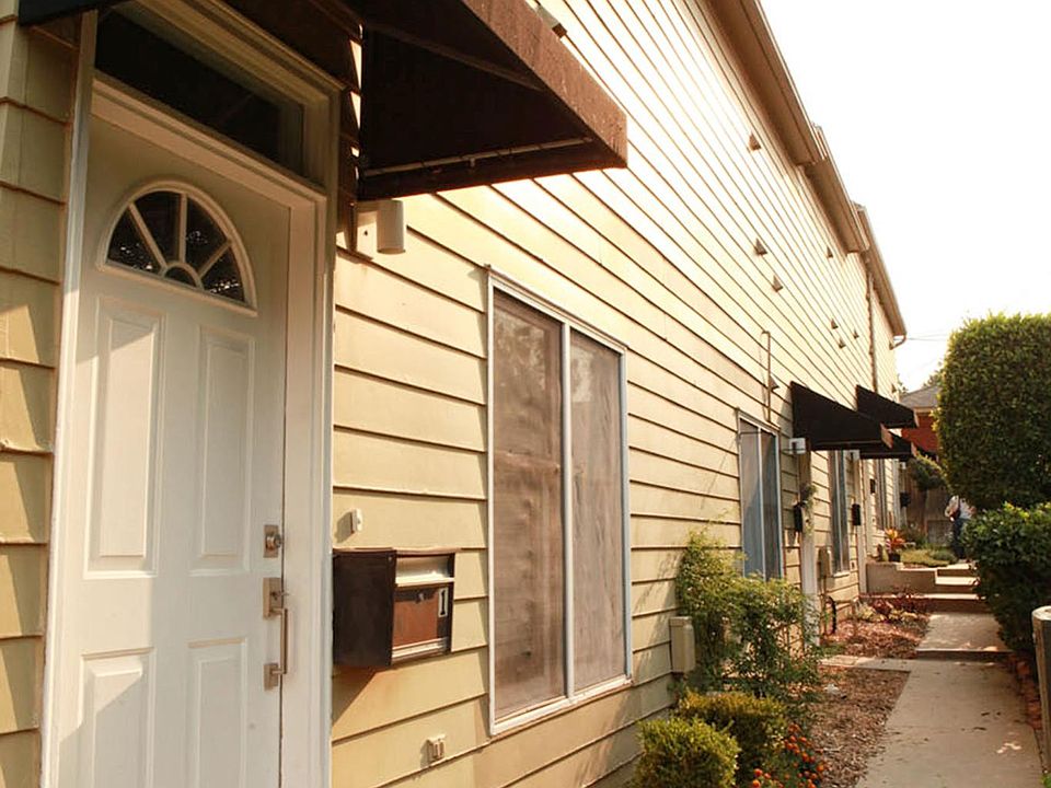 Walkway from Unit #1 looking east, showing awnings over front doors.