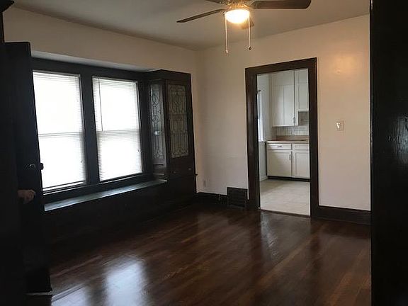 Large dining room with window seat and gorgeous leaded glass cabinets